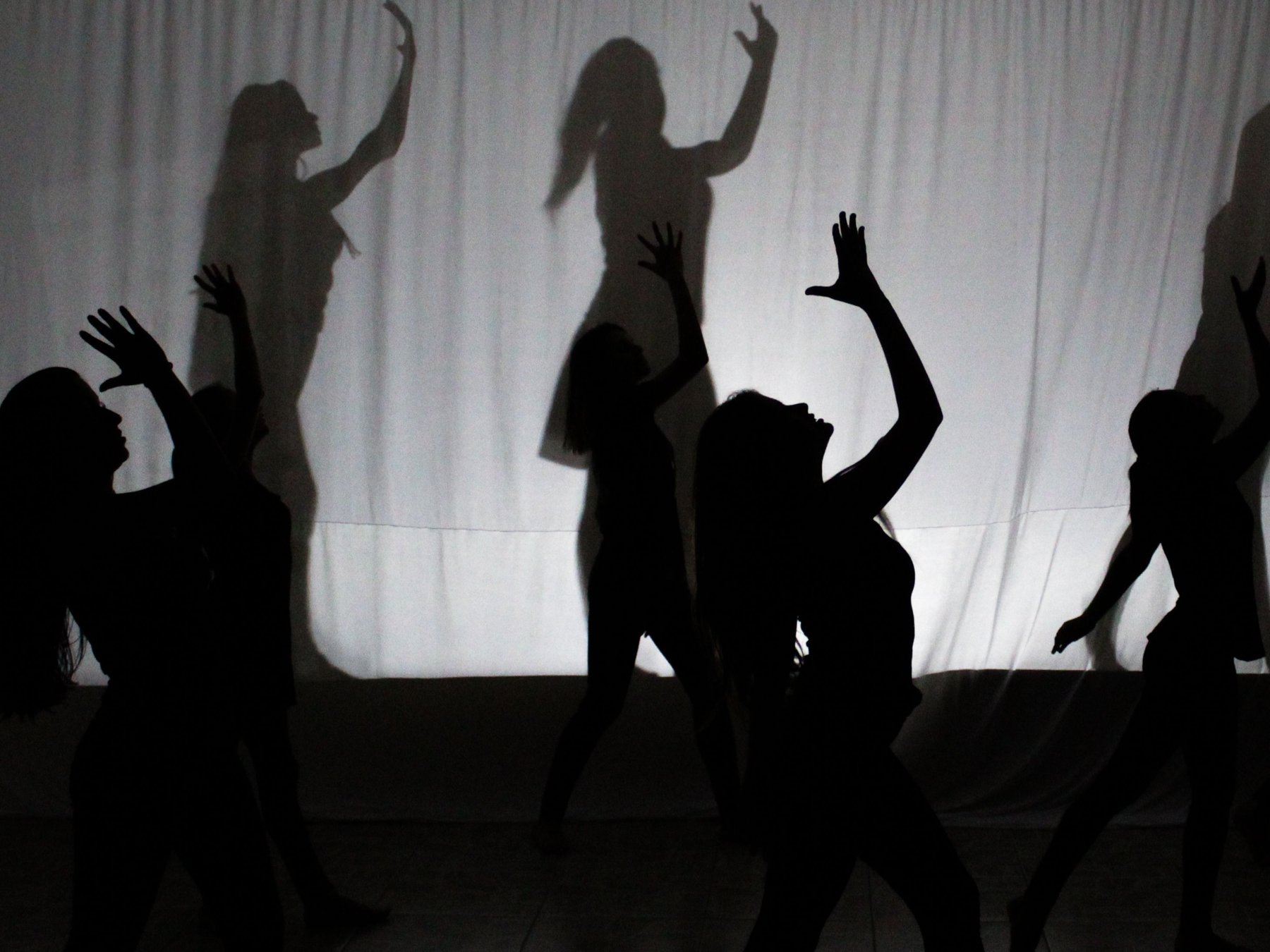 Figures in motion, arms raised